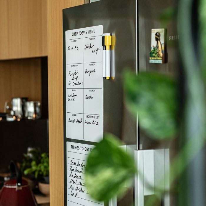 Fridge with a magnetic chalkboard attached, displaying a menu and to-do list.