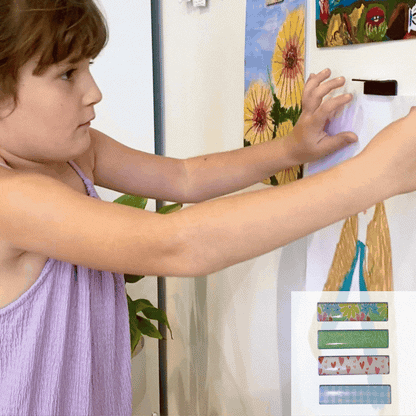video magnetic art clip child putting art work up on the wall