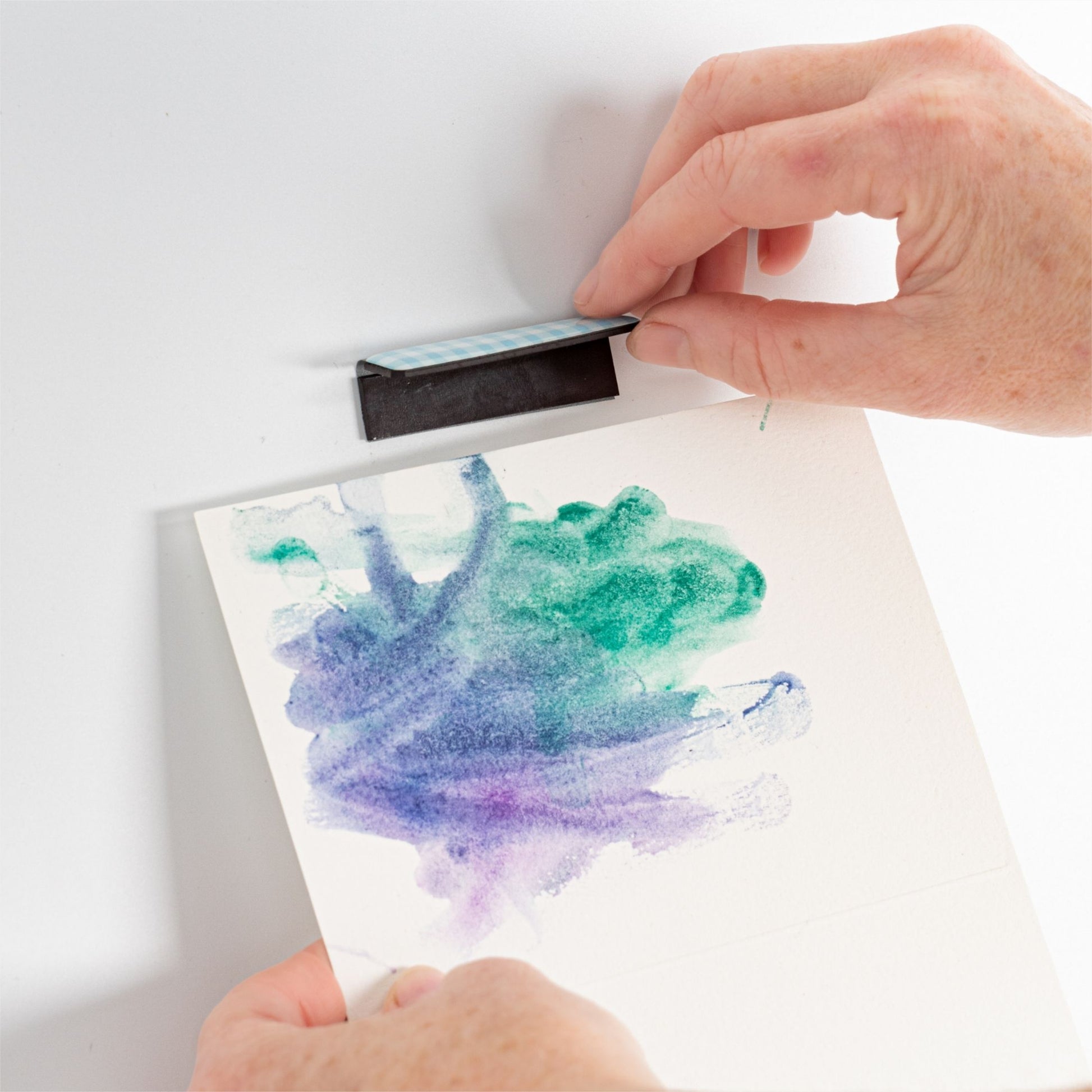 Magnetic blue art clip in use