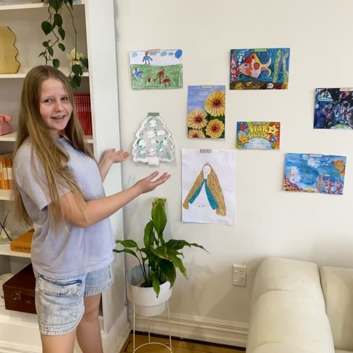 Wall of kids art up with magnetic art clips